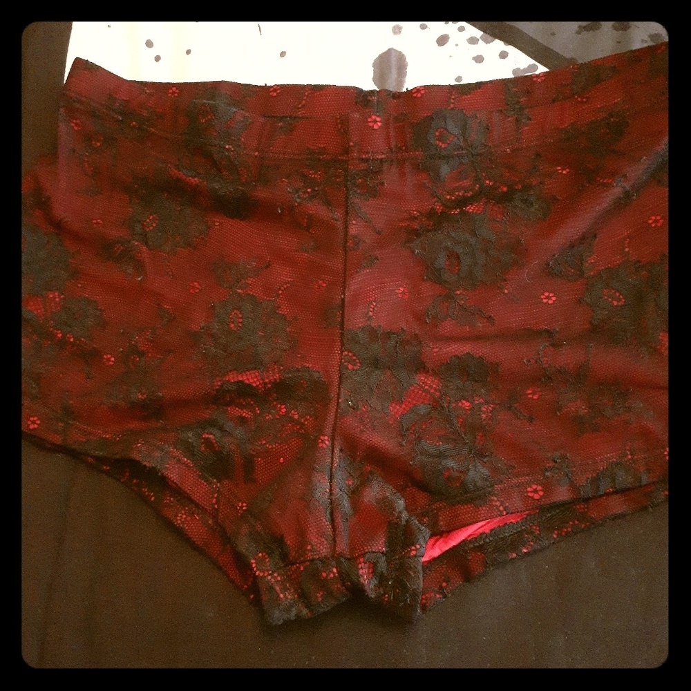 Sexy red hot pants covered in black lace